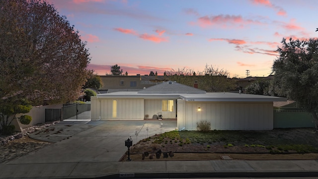 view of front facade with fence and driveway