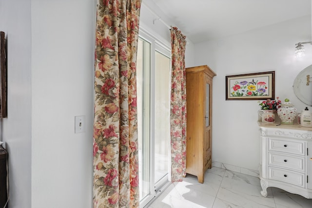 interior space featuring marble finish floor and vanity