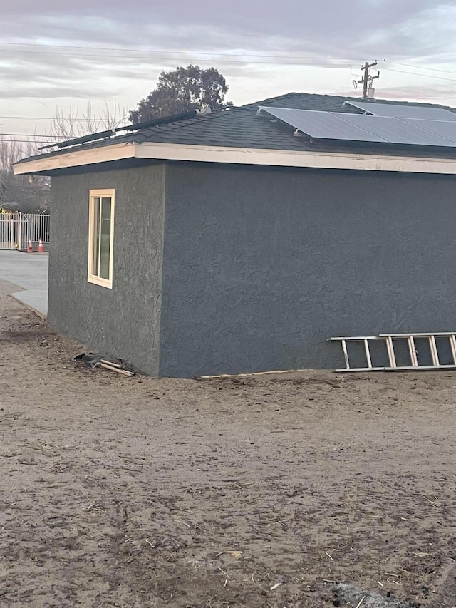 view of property exterior with solar panels