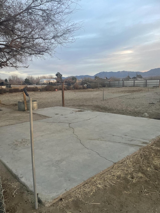 view of yard featuring a mountain view, a rural view, and a patio