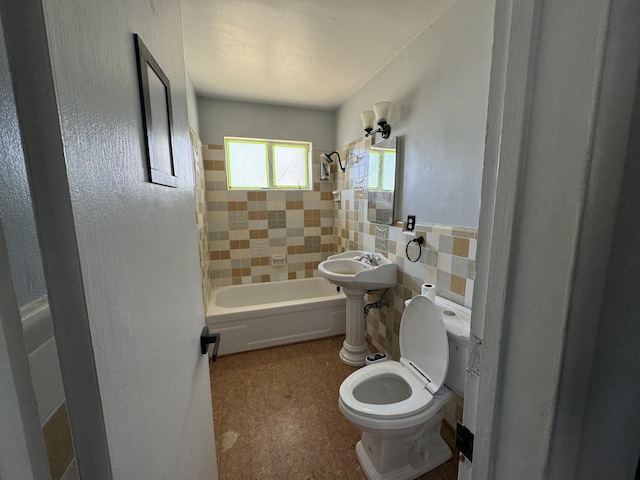 bathroom featuring toilet, tile walls, and tiled shower / bath