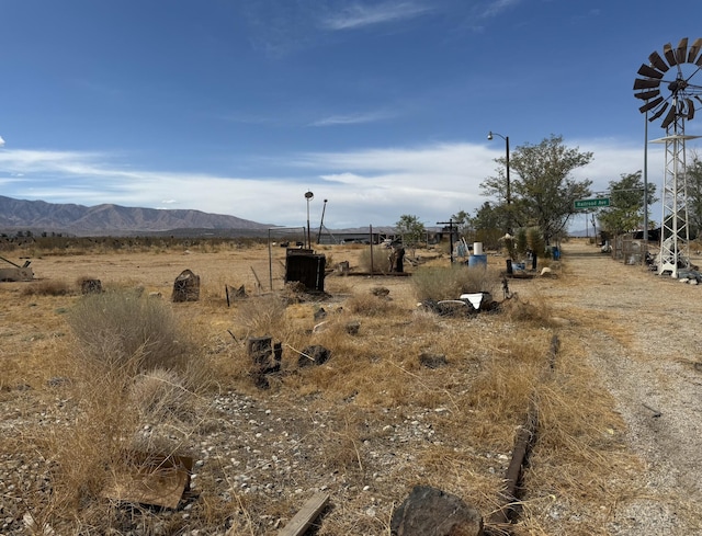 view of yard with a mountain view and a rural view