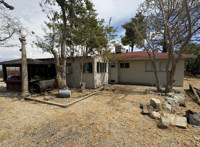 back of house featuring cooling unit