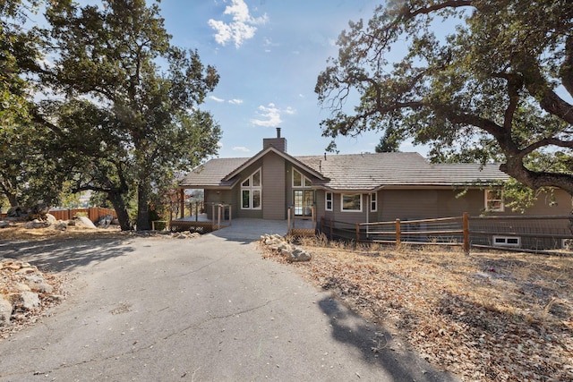 24500 Deertrail Dr, Tehachapi, CA 93561 - view of front of house featuring fence, a chimney, and driveway