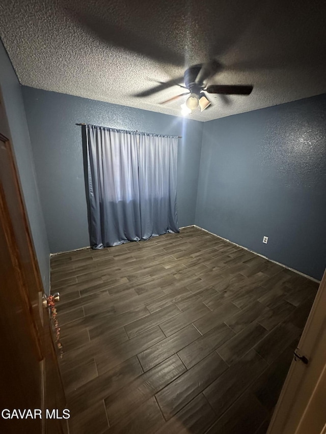43841 E 30th St, Lancaster, CA 93535 - empty room with dark wood-style floors, ceiling fan, and a textured ceiling