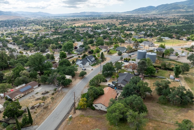 aerial view of property's location featuring a mountain backdrop and nearby suburban area