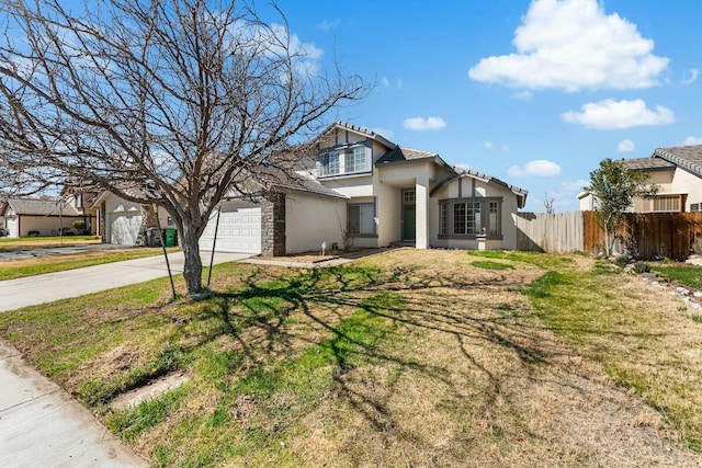 view of front of property with a garage, fence, driveway, stucco siding, and a front yard