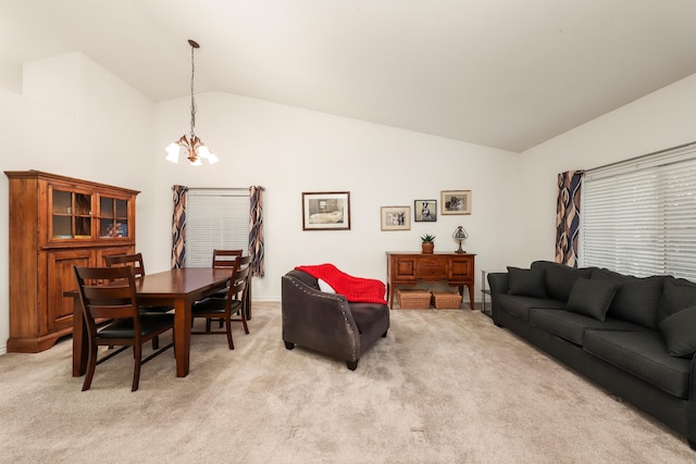 living room with light carpet, a chandelier, and lofted ceiling