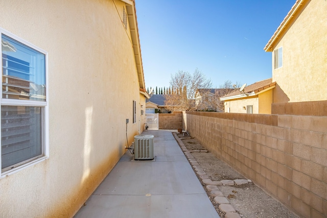 view of side of home featuring a patio and central air condition unit