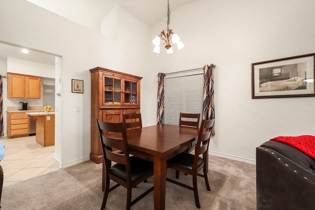 dining room with light colored carpet and a notable chandelier