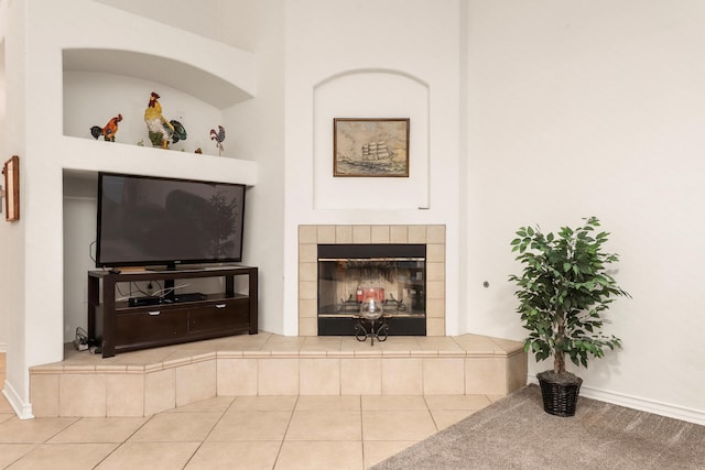 living room with tile patterned floors and a tiled fireplace