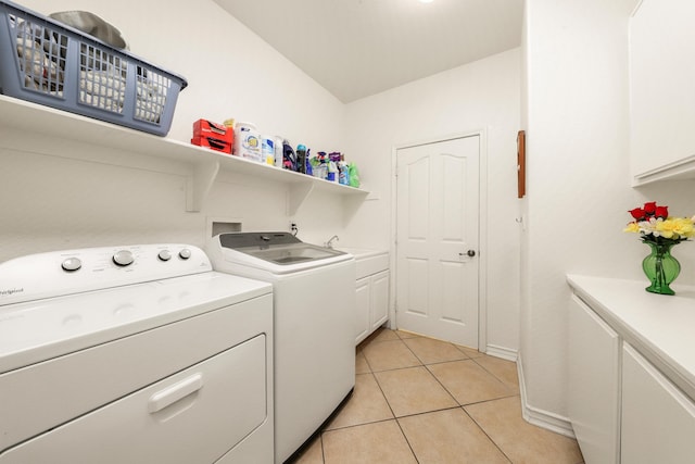 laundry room featuring light tile patterned flooring, cabinets, and independent washer and dryer