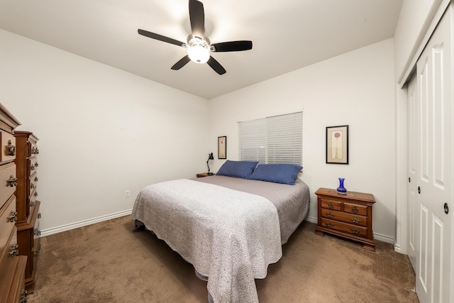 carpeted bedroom featuring ceiling fan and a closet