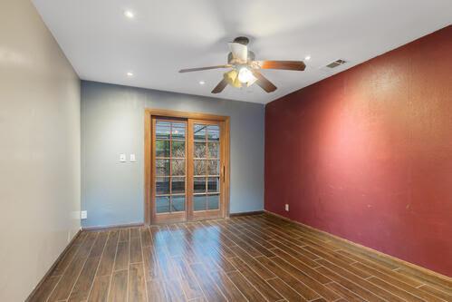 spare room featuring dark hardwood / wood-style floors and ceiling fan