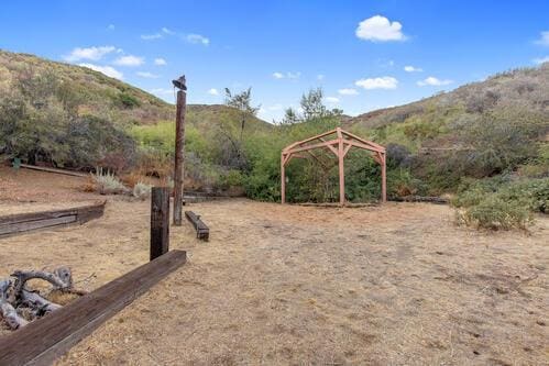 view of yard featuring a gazebo and a mountain view