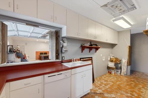 kitchen featuring white cabinetry, sink, and white dishwasher