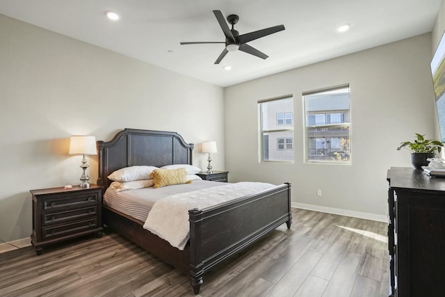 bedroom with dark hardwood / wood-style floors and ceiling fan