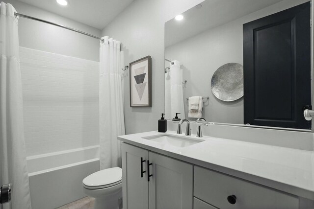 full bathroom with vanity, toilet, and shower / bath combo with shower curtain