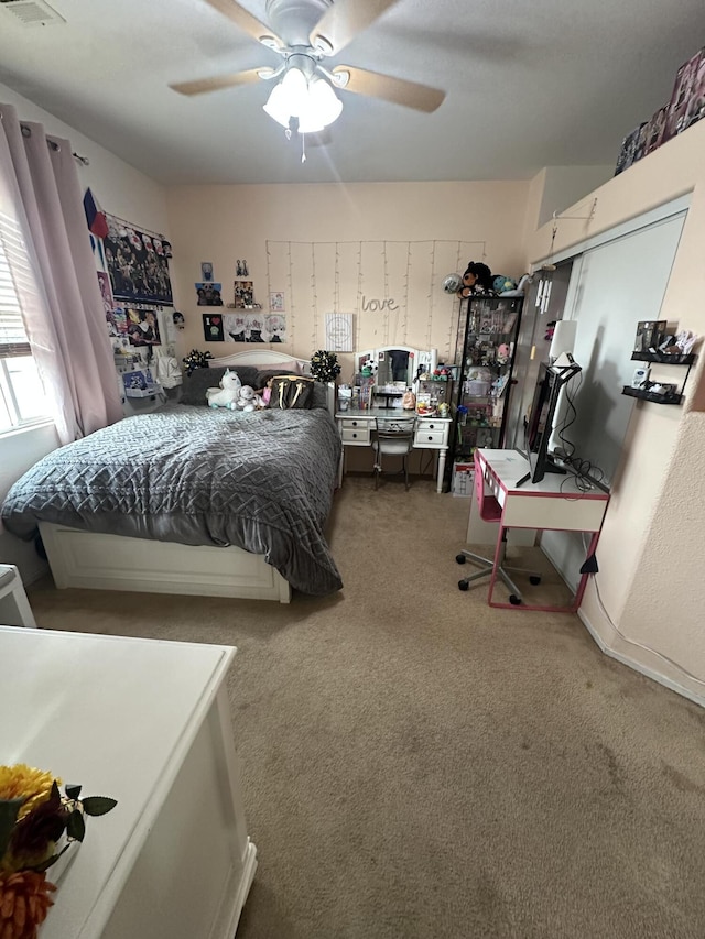 carpeted bedroom with ceiling fan