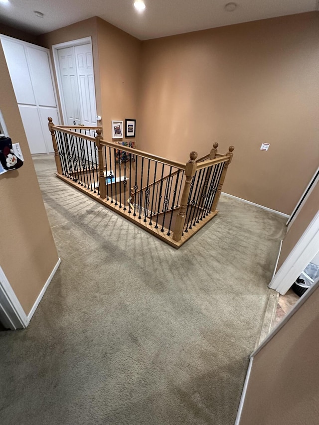 staircase featuring carpet flooring