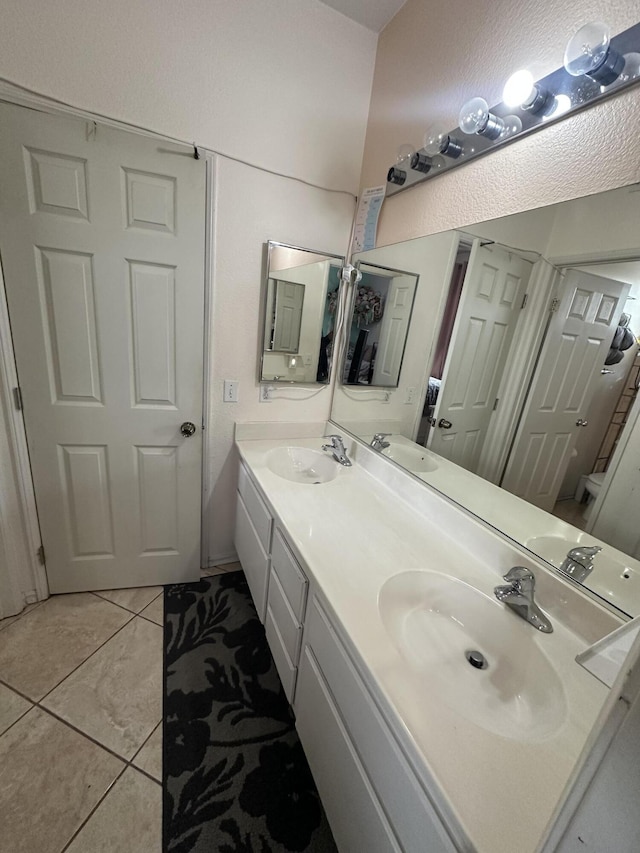 bathroom with tile patterned flooring and vanity