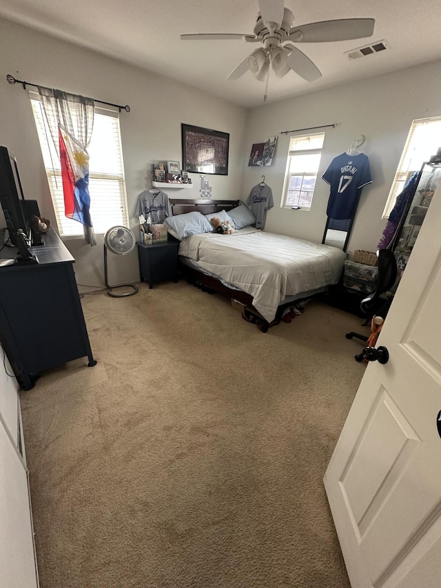 carpeted bedroom featuring ceiling fan