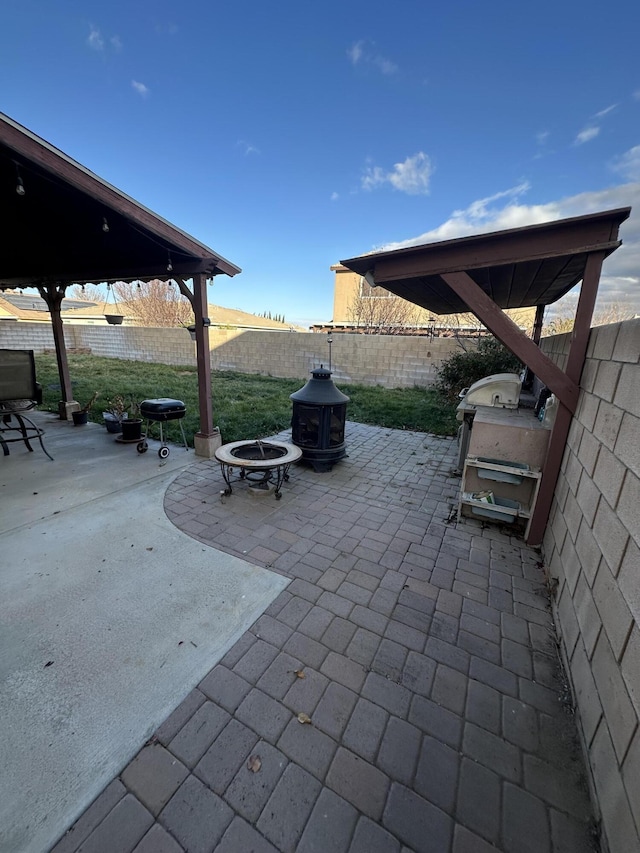 view of patio with a fire pit and area for grilling