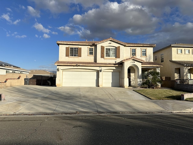 mediterranean / spanish home featuring a garage