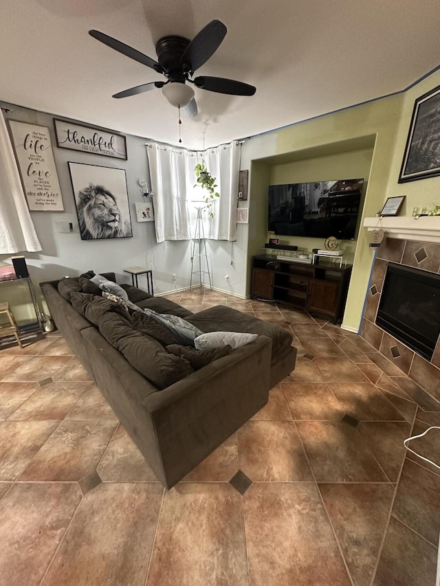 living room featuring ceiling fan and a fireplace