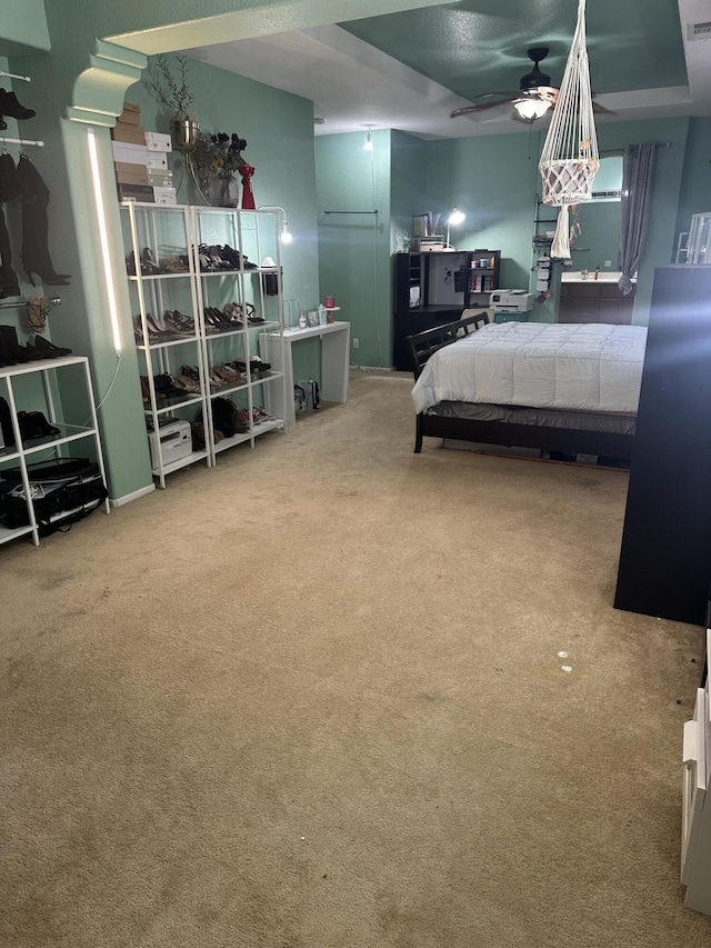 bedroom featuring ceiling fan and carpet