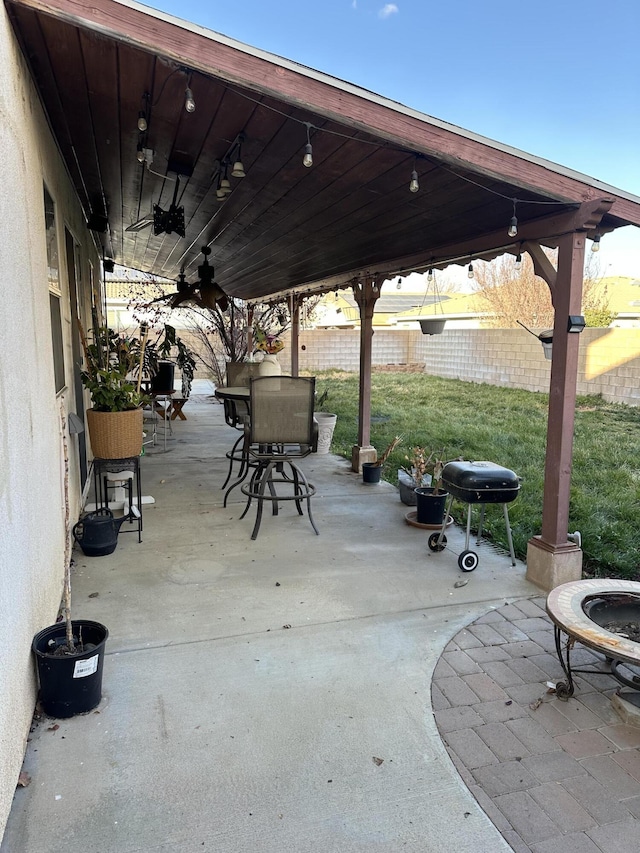 view of patio featuring ceiling fan and a grill