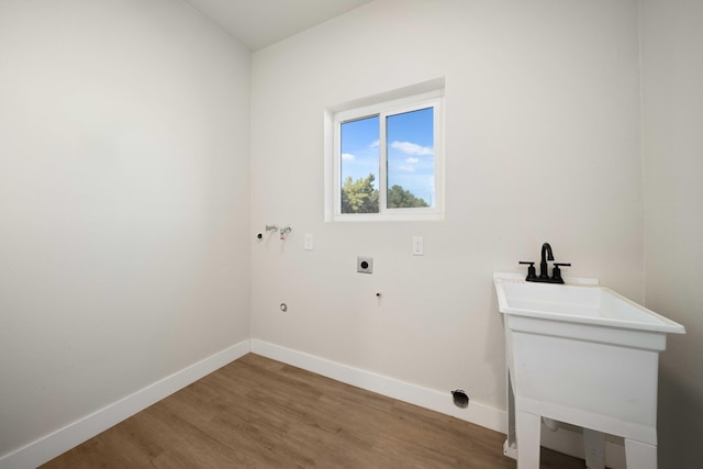 laundry room with hookup for an electric dryer, sink, hardwood / wood-style floors, and washer hookup