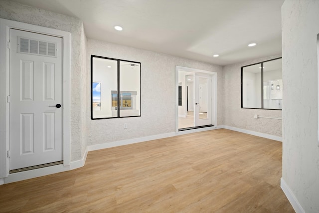 spare room with light hardwood / wood-style floors