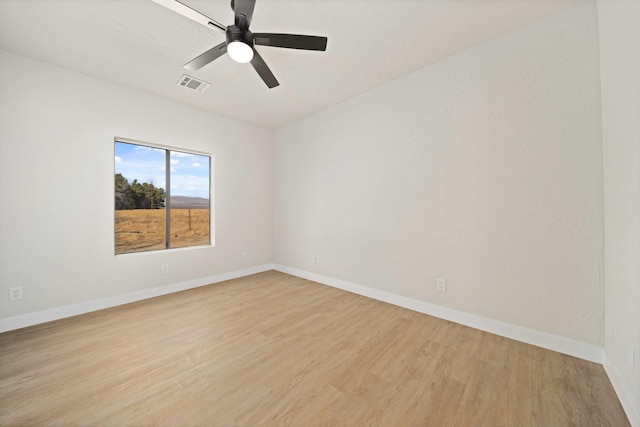 spare room with ceiling fan and light wood-type flooring