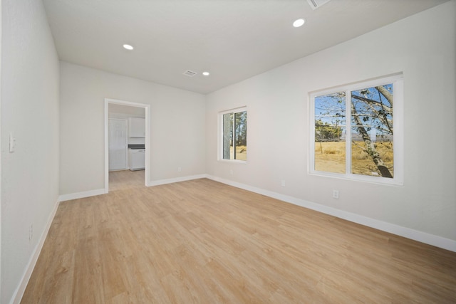 spare room featuring light wood-type flooring