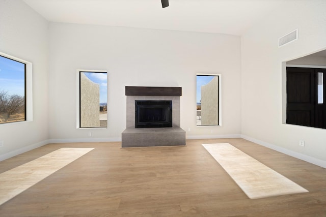 unfurnished living room featuring ceiling fan and light hardwood / wood-style floors