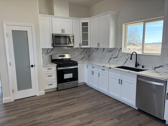 kitchen featuring white cabinets, dark wood-style floors, appliances with stainless steel finishes, and a sink