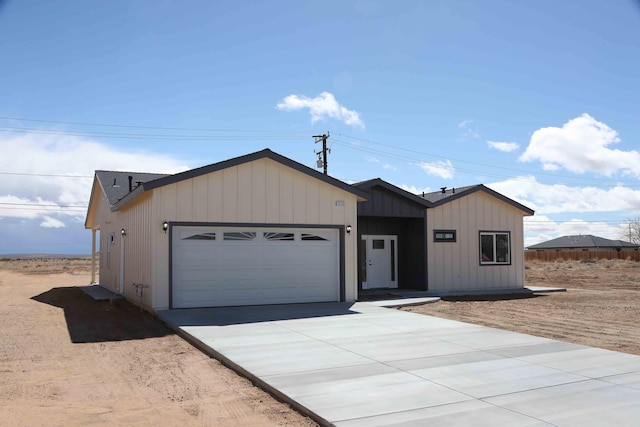 view of front of home with board and batten siding, concrete driveway, and a garage