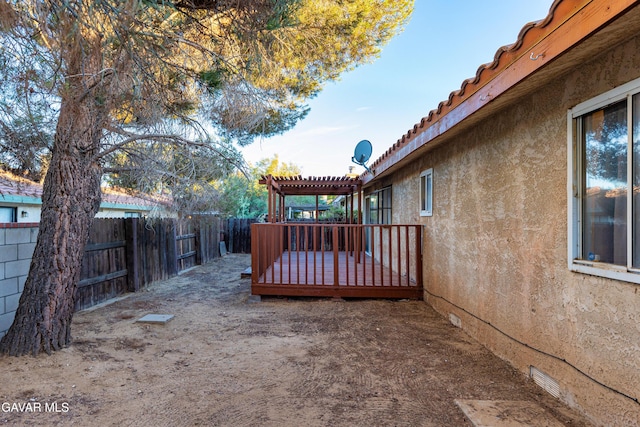 14332 Lear St, Mojave, CA 93501 - fenced backyard with a wooden deck and a pergola