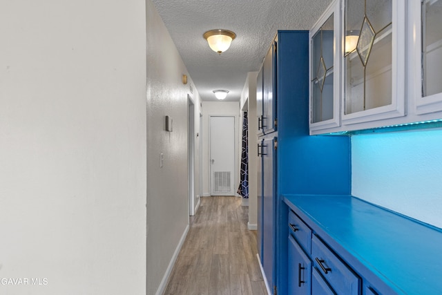 14332 Lear St, Mojave, CA 93501 - corridor with a textured ceiling and light wood-style flooring
