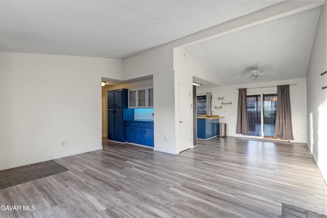14332 Lear St, Mojave, CA 93501 - unfurnished living room featuring vaulted ceiling, a ceiling fan, and wood finished floors