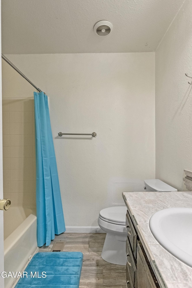 14332 Lear St, Mojave, CA 93501 - bathroom featuring wood finished floors, vanity, shower / bath combination with curtain, and a textured ceiling