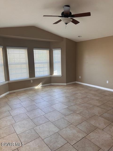 4961 Montiverde Rd, Mojave, CA 93501 - empty room with vaulted ceiling, a ceiling fan, and light tile patterned floors