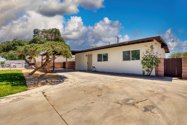 2068 Elm St, Rosamond, CA 93560 - view of front of home featuring fence and stucco siding