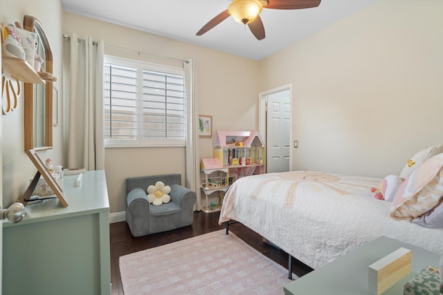 bedroom featuring wood finished floors, baseboards, and ceiling fan