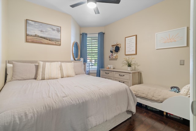 bedroom with a ceiling fan and dark wood-style flooring