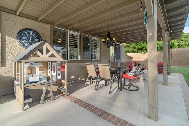 view of patio featuring outdoor dining area and fence