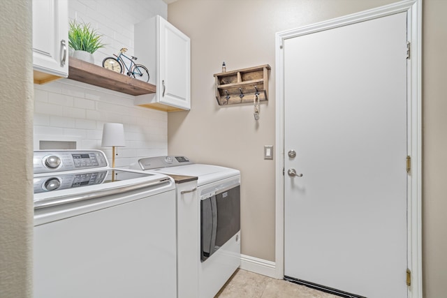laundry area with washing machine and clothes dryer and cabinet space