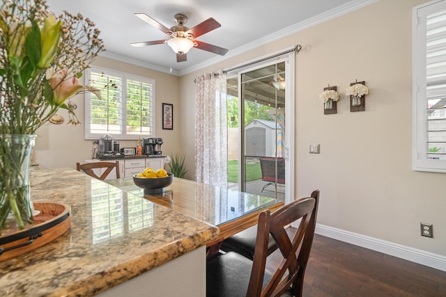 dining space with baseboards, ornamental molding, a ceiling fan, and dark wood-style floors