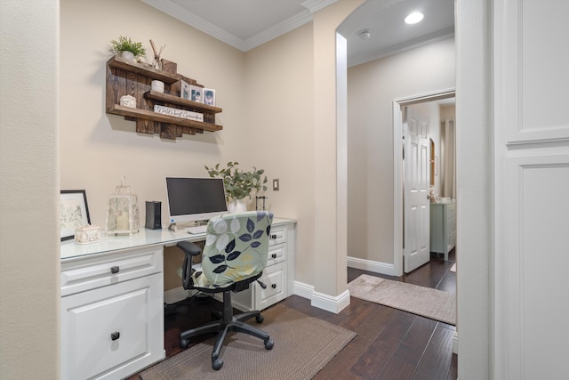 office space featuring baseboards, ornamental molding, built in desk, and dark wood-type flooring